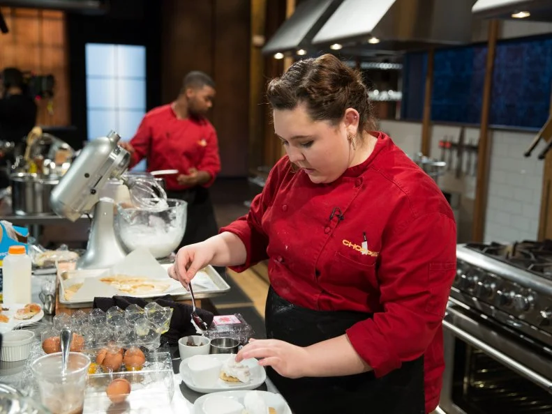 Teen competitor Tommi Rae Fowler cooking during a competition, as seen on Food Networkâ  s Chopped, Season 21.