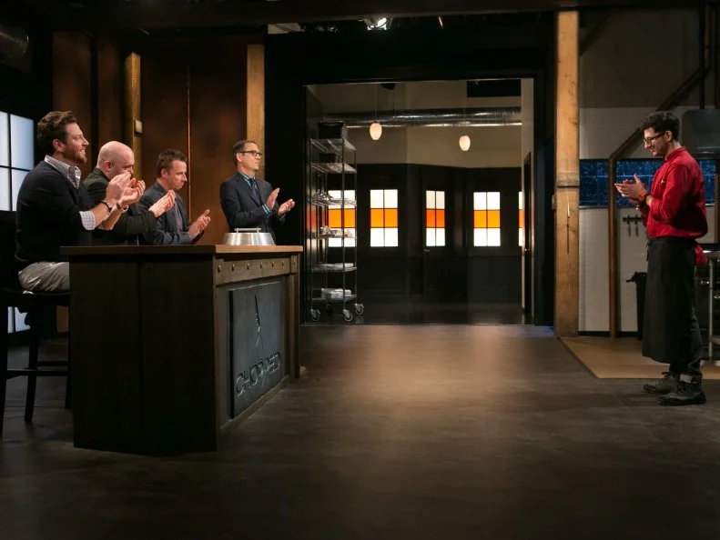 Chef Giorgio Rapicavoli receives congratulations from Chopped host Ted Allen and judges: Scott Conant, Chris Santos and Marc Murphy after winning a slot in the Chopped Ultimate Championship competition, the winner of which receives $50,000 and a new car from Buick, as seen on Food Network's Chopped, Season 21.