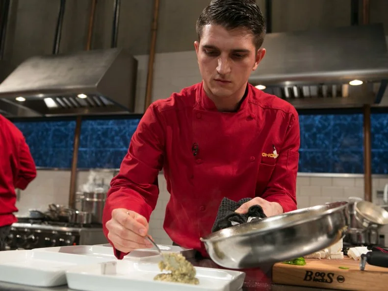 Chef Tom McKenna works on his entree that must include: whole dressed squab, stuffed grape leaves feta cheese and cherry cola as he competes for a slot in the Chopped Ultimate Championship competition, the winner of which receives $50,000 and a new car from Buick, as seen on Food Network's Chopped, Season 21.