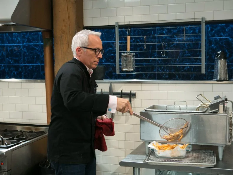 Chef Geoffrey Zakarian working on his dish that must include: eel, pepihuates, shaved coconut and sea beans, as seen on Food Network's Chopped, Season 21.