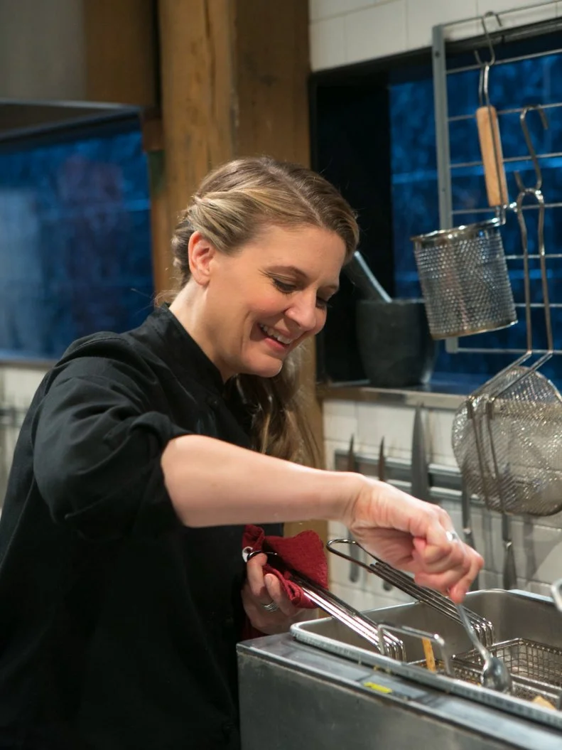 Chef Amanda Freitag having fun as he works on his dish that must include: whole suckling pig, kebab sauces, fiddlehead ferns and fresh corn tortillas, as seen on Food Network's Chopped After Hours, Season 21.