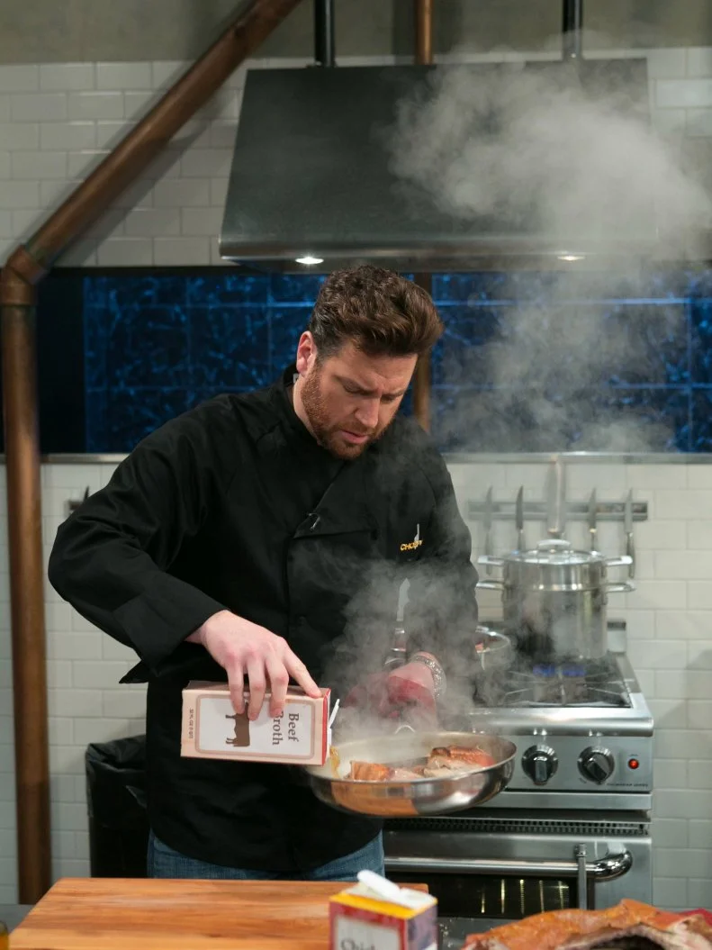 Chef Scott Conant as he works on his dish that must include: whole suckling pig, kebab sauces, fiddlehead ferns and fresh corn tortillas, as seen on Food Network's Chopped After Hours, Season 21.