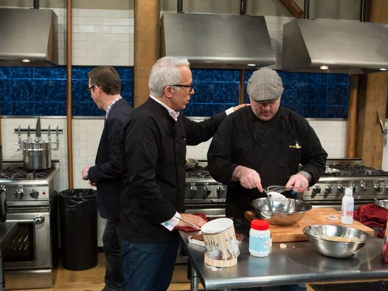 Chefs Geoffrey Zakarian and Chris Santos joke around while they work with the ingredients from the "short order" episode: banana pudding, vanilla ice cream, icing, brownie mix, as seen on Food Network's Chopped After Hours, Season 21.