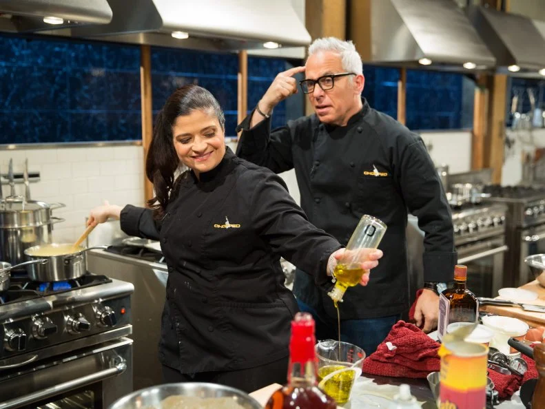 Alex Guarnaschelli and Geoffrey Zakarianduring a dessert theme webisode cooking with Mississippi mud pie, brie, maraschino cherries and potato crisps, as seen on Food Network’s Chopped After Hours, Season 26.