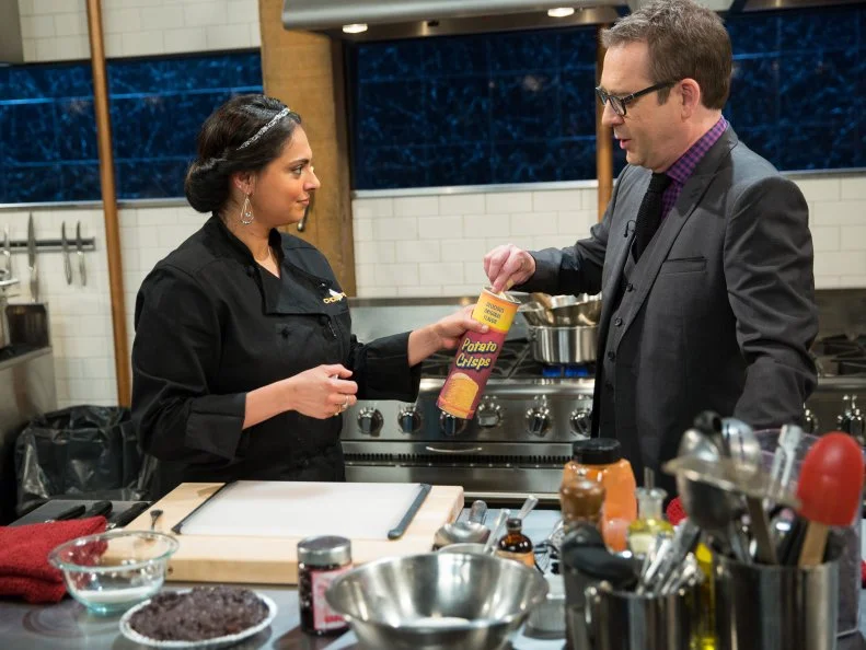 Ted Allen and Maneet Chauhan
during a dessert theme webisode cooking with Mississippi mud pie, brie, maraschino cherries and potato crisps, as seen on Food Network’s Chopped After Hours, Season 26.