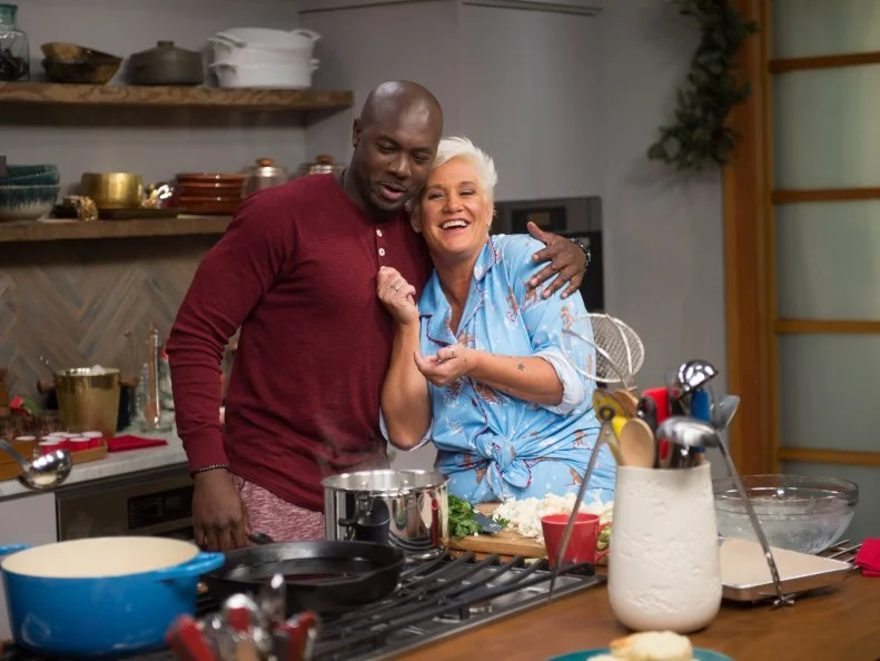 Host Bobby Flay and his guests Alex Guarneschelli, Anne Burrell, Katie Lee, Sunny Anderson, Eddie Jackson, Geoffrey Zacharian, and Scott Conant prepare dinner as seen on Food Network’s Bobby Flay’s Barbecue Addiction, Christmas at Bobby’s Special