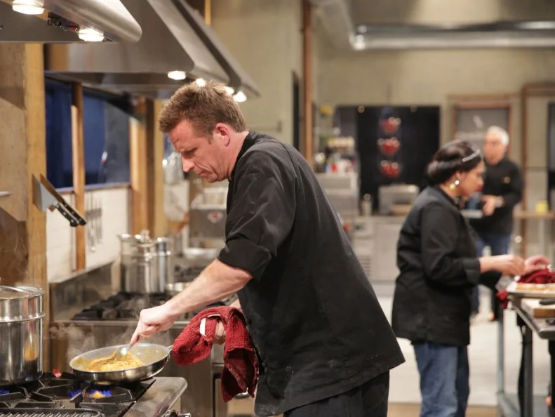 Marc Murphy, using pork roll, baby eggplant, pizza dough and Chinese spaghetti sauce, during a family affair theme webisode, as seen on Food Network’s Chopped After Hours, Season 26.