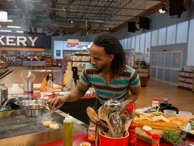 Chef Darion Williams prepares his dish during Game 1, Grocery List, as seen on Food Network's Guy's Grocery Games, Season 7.