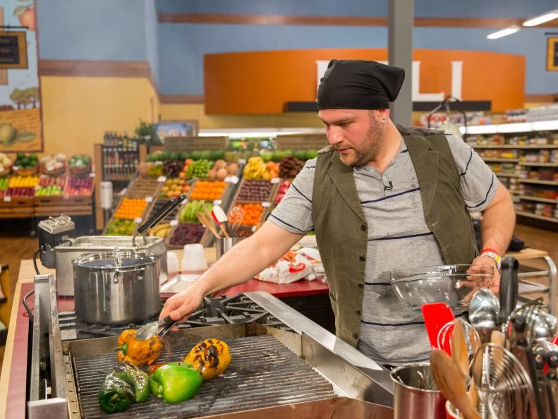 Chef Salvatore Boscarello prepares his dish during Game 2, Odd/Even, as seen on Food Network's Guy's Grocery Games, Season 7.