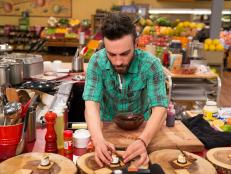 Chef Trevor Ball plates his dish during Game 1, Let It Roll, as seen on Food Network's Guy's Grocery Games, Season 7.