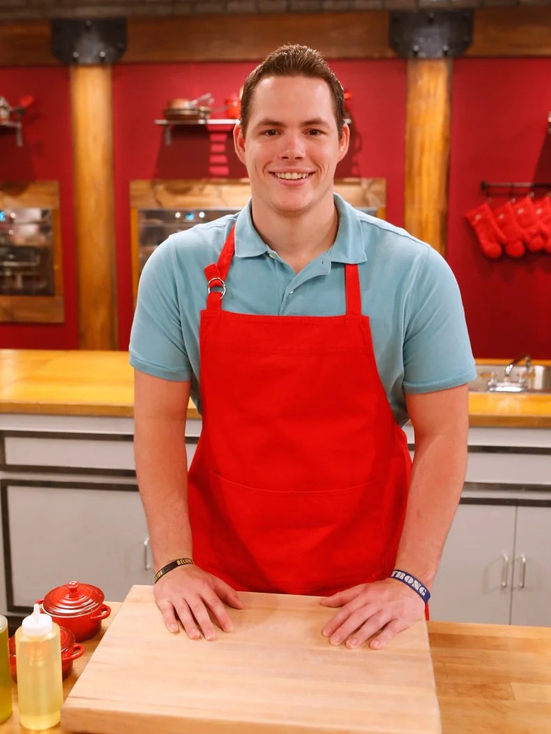 Red team recruit Taylor Hoopers poses on the set of Food Network's Worst Cooks in America, Season 8.