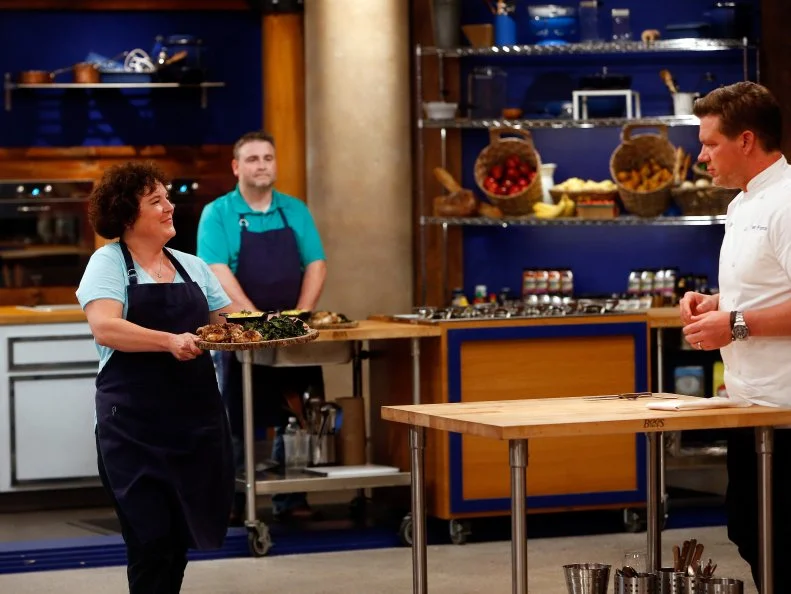 Host Tyler Florence tastes blue team recruit Jeni Erdman's recreation of Florence's Sticky Brick Chicken with Creamed Corn and Kale dish as seen on Food Network's Worst Cooks in America, Season 8.