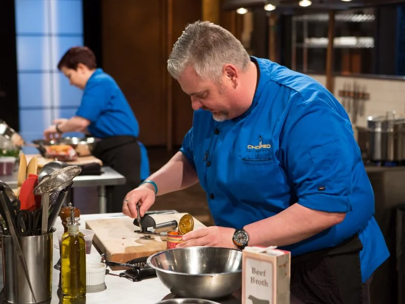 Chefs Emily Chapman and James Major work on their entrées that must include: fried brain sandwiches, dried pomegranate seeds, chocolate mint and spaghetti rings for Chopped: Impossible tournament, as seen on Food Network's Chopped, Season 27.