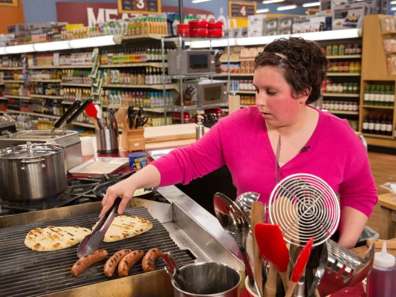 Chef Caitie Maharg prepares her dish during Game 1, Un-Gredients, as seen on Food Network's Guy's Grocery Games, Season 7.
