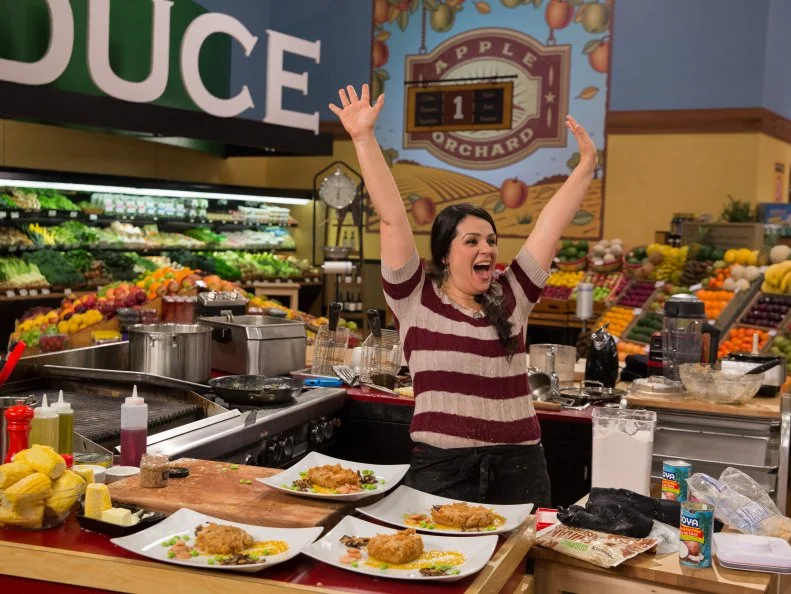 Chef Veronica Eiken celebrates after finishing her dish during Game 1, Express Lane, as seen on Food Network's Guy's Grocery Games, Season 7.