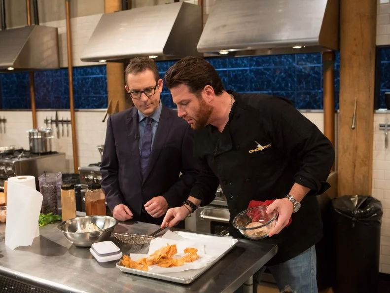 Chopped After Hours host Ted Allen checks in with chef Scott Conant while he  works on his dish that must include the late night foods:a rice and cheese burrito, chocolate milk, canned whipped cream and apple pies, as seen on Food Network's Chopped After Hours, Season 22.