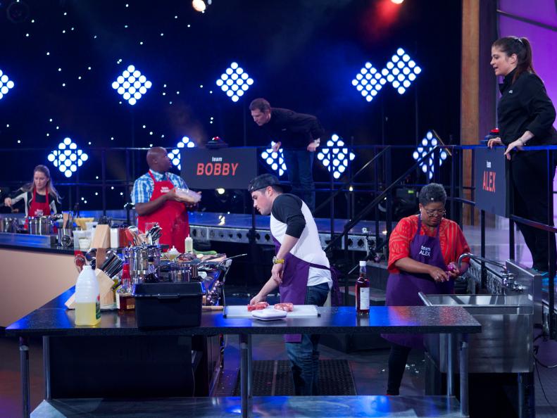 Chef Alex Guarnaschelli mentors August Dannehl and Sherri Williams of Team Alex with Angela George (L) and Joseph Harris with Chef Bobby Flay during the first challenge where each team was given a different assignment. Team Alex was assigned Meat & Potatoes, Team Bobby was assigned Spaghetti & Meatballs, Team Michael was assigned Surf & Turf and Team Curtis was assigned Chicken & Waffles, as seen on Food Network's All-Star Academy, Season 1.