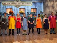 Contestants listen to host Bobby Dean as he introduces the first pre-heat challenge during which they will bake "flower cupcakes", as seen on Food Network's Spring Baking Championship, Season 1.