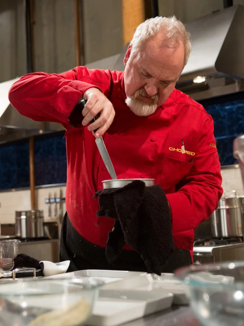 Chef Art Smith working on his dessert that must include: Maple smoked Cheddar cheese, almond flour, mayonnaise and datesfor Chopped $75,000 charity All-Stars competition, as seen on Food Network's Chopped, Season 24.