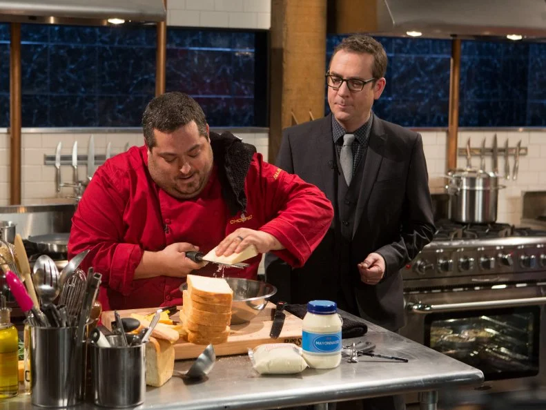 Chopped host Ted Allen checks in on chef Eric Greenspan as he works on his dessert that must include: Maple smoked Cheddar cheese, almond flour, mayonnaise and datesfor Chopped $75,000 charity All-Stars competition, as seen on Food Network's Chopped, Season 24.