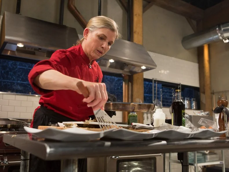 Chef Mary Sue Milliken works on her entree that must include: veal sweetbreads, fondue, artichokes and green chili for Chopped $75,000 charity All-Stars competition, as seen on Food Network's Chopped, Season 24.