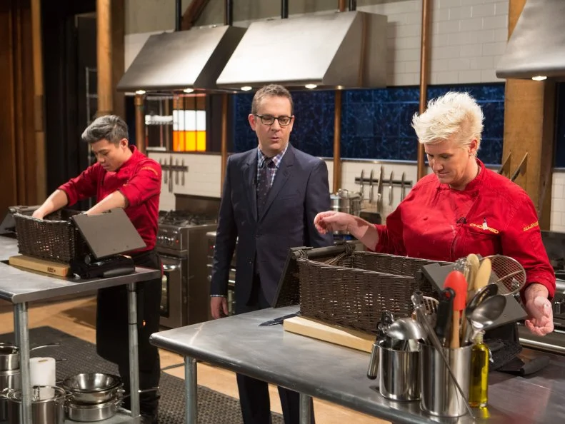 Chopped host Ted Allen announcing to chefs Hung Huynh and Anne Burrell their mystery basket ingredients at the start of the dessert round for Chopped $75,000 charity All-Stars competition, as seen on Food Network's Chopped, Season 24.