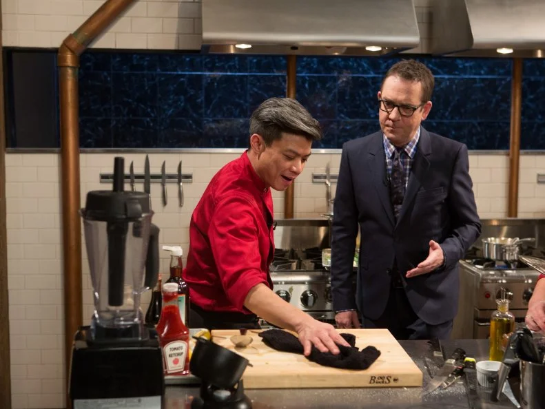 Chopped host Ted Allen checks in on chef Hung Huynh as he works on his entree that must include: veal sweetbreads, fondue, artichokes and green chili for Chopped $75,000 charity All-Stars competition, as seen on Food Network's Chopped, Season 24.