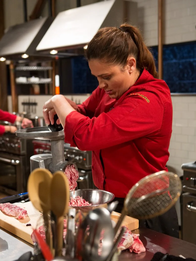 Chef Antonia Lofaso works on her entree that must include:  lamb ribs, kumquats, white radicchio and spoon fruit for Chopped All-Stars $75,000 charity competition, as seen on Food Network's Chopped, Season 24.