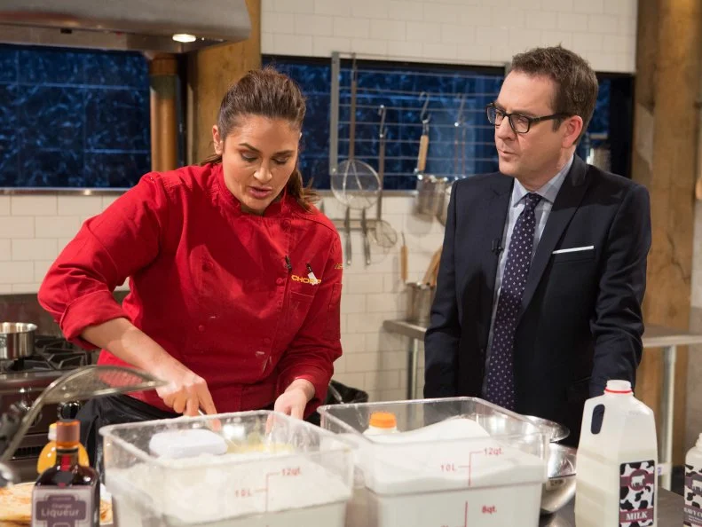 Chopped host Ted Allen checks in on chef Antonia Lofaso as she works on her dessert that must include: ghee, m'smen, whole walnuts and orange flavored water for Chopped All-Stars $75,000 charity competition, as seen on Food Network's Chopped, Season 24.