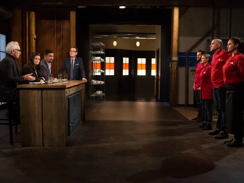 Chefs: Marcel Vigneron, Cat Cora, Michael Psilakis and Antonia Lofaso  stand in front of host Ted Allen and judges: Geoffrey Zakarian, Alex Guarnaschelli and Aaron Sanchez to defend their appetizers that must have included: Mojama, baby zucchini, macron almonds and coconut macaroons for Chopped All-Stars $75,000 charity competition, as seen on Food Network's Chopped, Season 24.