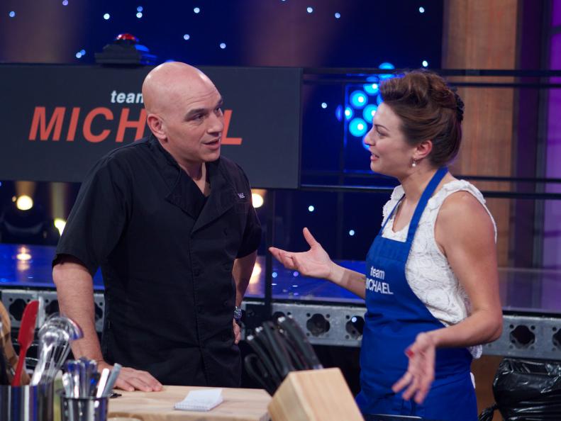 Chef Michael Symon (L) with cook Vanessa Craig during the mentoring of the first challenge, where Chef and Cook work together to make egg dish, as seen on Food Network's All-Star Academy, Season 1.