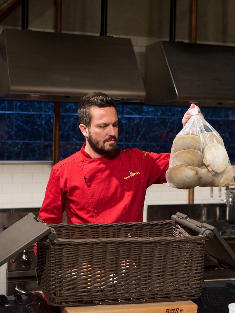 Chef Fabio Viviani pulling out the mystery basket ingredients for Chopped All-Stars $75,000 charity competition, as seen on Food Network's Chopped, Season 24.