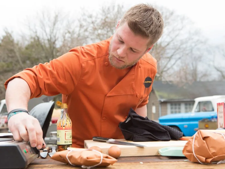 Chef Matty Melehes works on his appetizer that must include: raw hamburger, salsa con queso, zucchini and hotdogs, as seen on Food Network's Chopped, Grill Masters Special.
