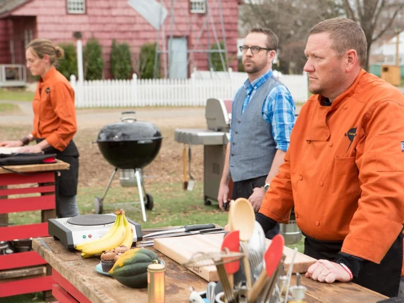 Chopped host Ted Allen and chefs Mary Brent Gaylean and Stan Hays moments before the chefs make dessert with:acorn squash, cupcakes, bananas and ras el hanout, as seen on Food Network's Chopped, Grill Masters Special.