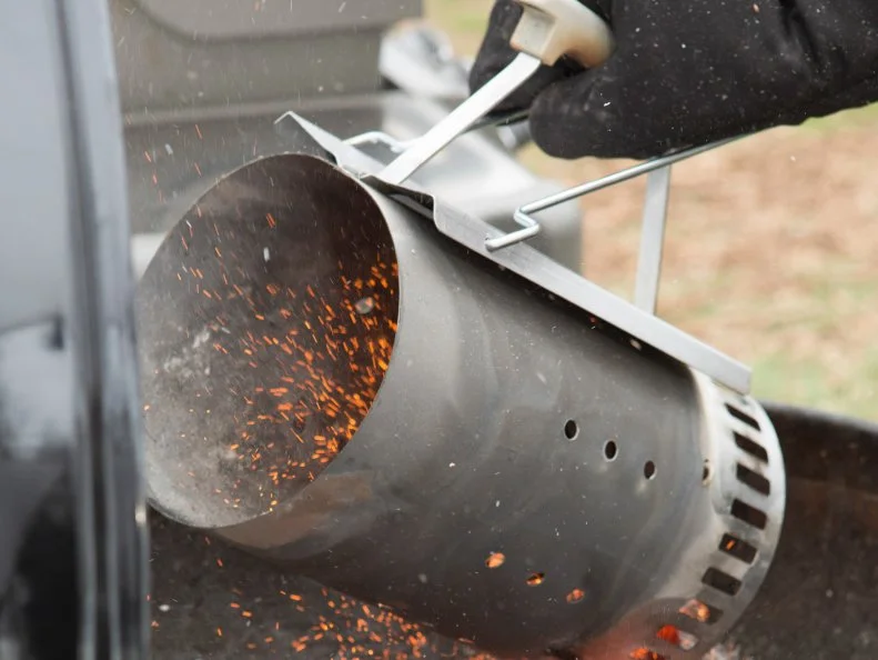 Hot Coals going into a grill, as seen on Food Network's Chopped, Grill Masters Special.