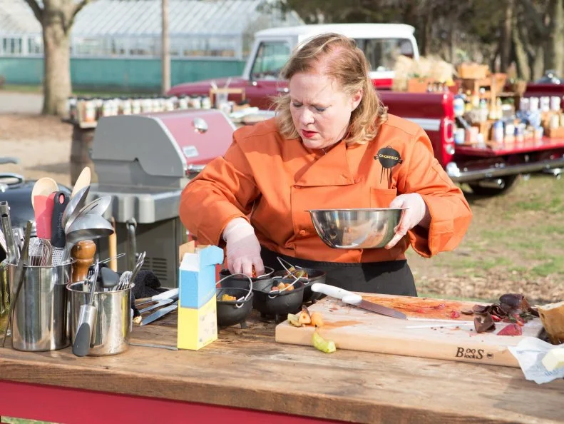 Chef Leslie Roark Scott working on her dessert that must include:fruit skewers, quick pan popcorn, amaretto and panettone, as seen on Food Network's Chopped, Grill Masters Special.