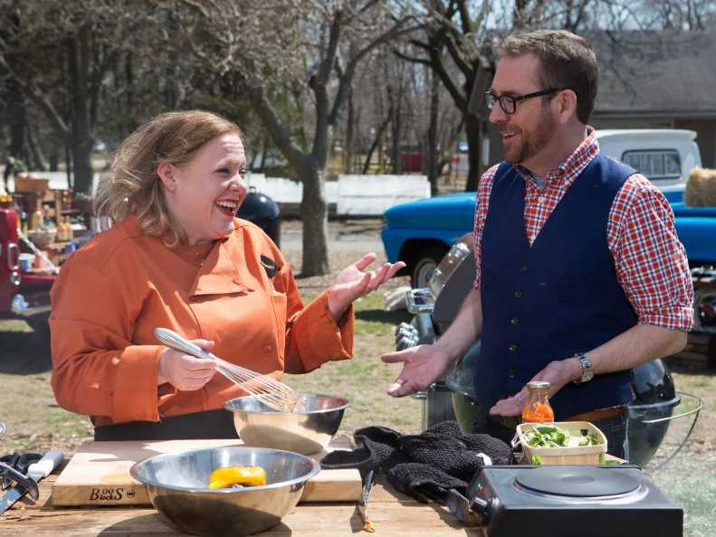 Chopped host Ted Allen checks in on chef Leslie Roark Scott as she works on her entree that must include: spiny lobsters, carrot ketchup, dandelion greens and cheese and jalapeÃ±o sausage, as seen on Food Network's Chopped, Grill Masters Special.