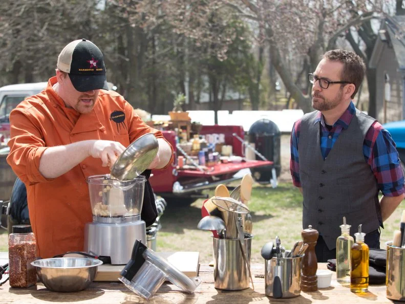 Chopped host Ted Allen checks in on chef Ash Fulk while he works on his entree that must include: Monchong (fish) ramps, macadamia nuts and galia melon, as seen on Food Network's Chopped, Grill Masters Special.