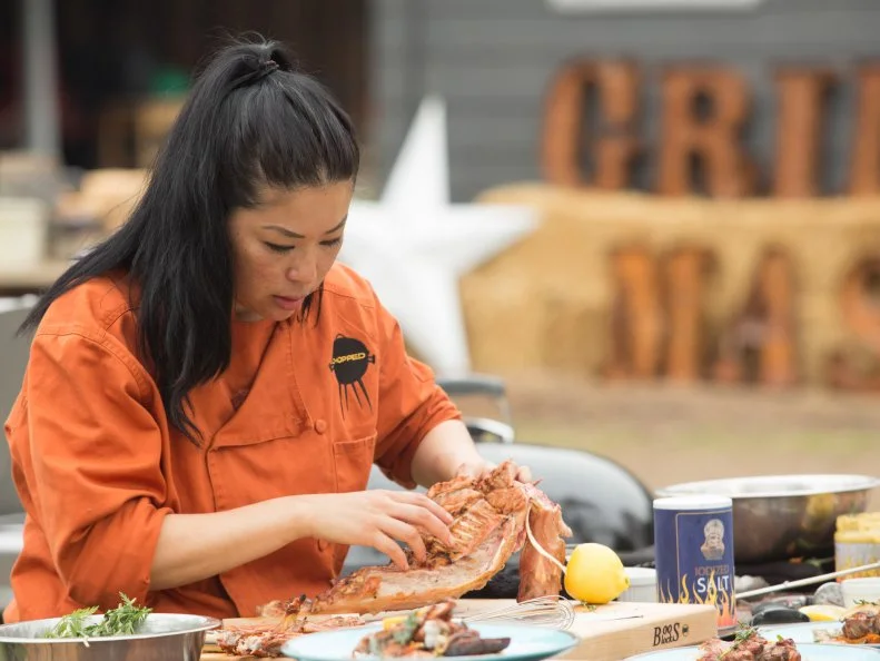 Chef Angie Mar works on her entree that must include: baby goat, rainbow carrots, watermelon and kokoretsi, as seen on Food Network's Chopped, Grill Masters Special.