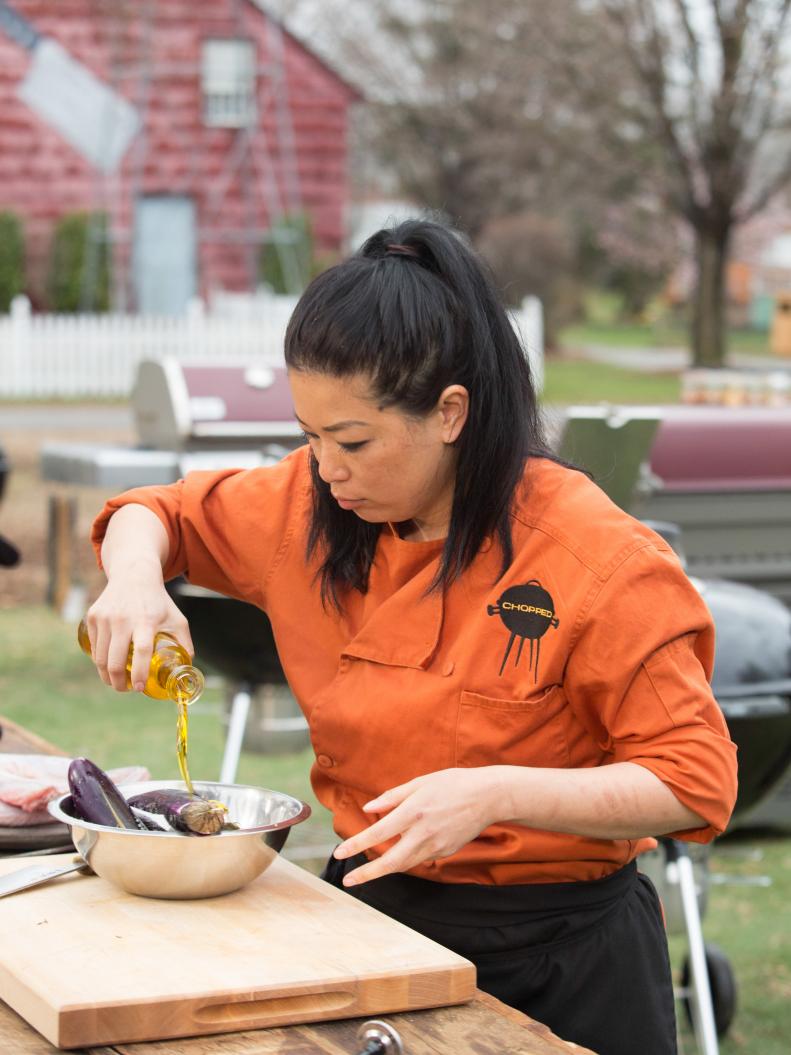 Chef Angie Mar works on her appetizer that must include: rattlesnake, lemonade and iced tea drink, Japanese eggplant and hush puppies, as seen on Food Network's Chopped, Grill Masters Special.