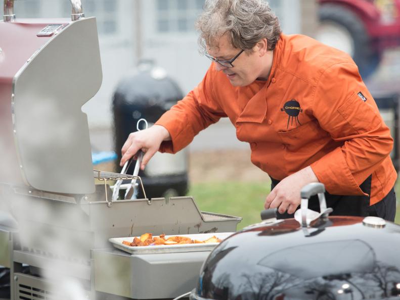 Chef Chris Hart works on his appetizer that must include: rattlesnake, lemonade and iced tea drink, Japanese eggplant and hush puppies, as seen on Food Network's Chopped, Grill Masters Special.
