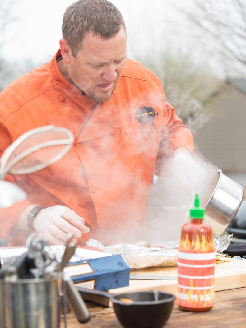 Chef Stan Hays works on his appetizer that must include: rattlesnake, lemonade and iced tea drink, Japanese eggplant and hush puppies, as seen on Food Network's Chopped, Grill Masters Special.