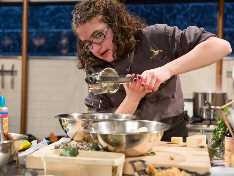 15 year old Anna Mindell works on her entree that must include: hanger steak, lollipop kale, apple crisp and spray cheese for Chopped Teen Week $25,000 tournament, as seen on Food Network's Chopped, Season 25.