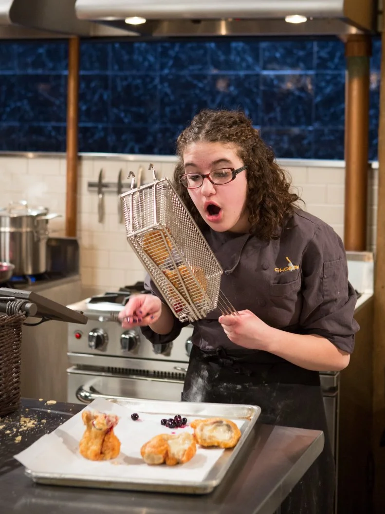 15 year old Anna Mindell works on her dessert that must include: fruit chew candies, instant yogurt pudding mix, tortilla chips and blueberries for Chopped Teen Week $25,000 tournament, as seen on Food Network's Chopped, Season 25.