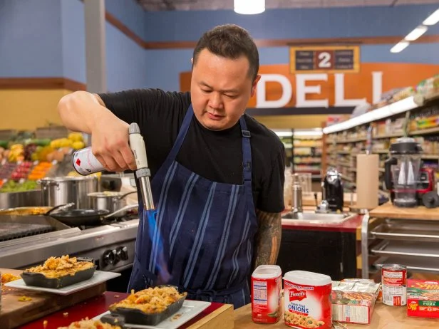 Celebrity Chef Jet Tila prepares his dish during Game 2, Meals from the Middle, as seen on Food Network's Guy's Grocery Games, Season 7.