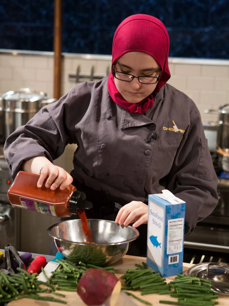 15 year old Salma Zahran works on her appetizer that must include: wild langoustines, asian long beans, yuzu juice and Japanese sweet potatoes for Chopped Teen Week $25,000 tournament, as seen on Food Network's Chopped, Season 25.