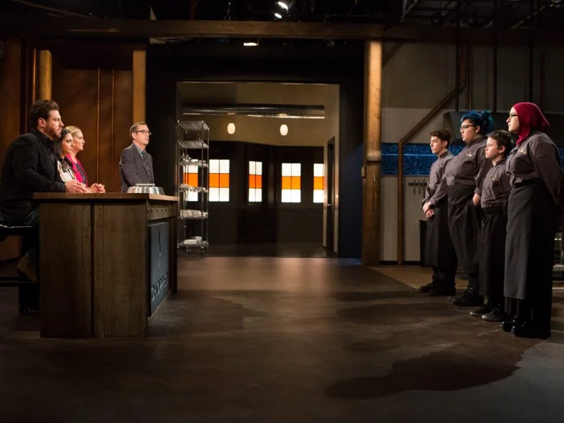 (L-R) Teens: 17 year old Nino Asaro, 17 year old Alyssa Chacon, 13 year old Peter Wenger and 15 year old Salma Zahran stand before Chopped host Ted Allen and judges: Scott Conant, Maneet Chauhan and Amanda Freitag moments after finding out which teens will move on to cook in the next round and which teen has been Chopped for Chopped Teen Week $25,000 tournament, as seen on Food Network's Chopped, Season 25.