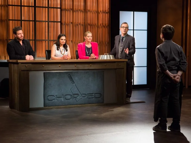 13 year old Peter Wenger stands before Chopped host Ted Allen and judges: Scott Conant, Maneet Chauhan and Amanda Freitag moments after finding out he has become a Chopped Champion and secured a spot in the $25000 tournament for Chopped Teen Week $25,000 tournament, as seen on Food Network's Chopped, Season 25.