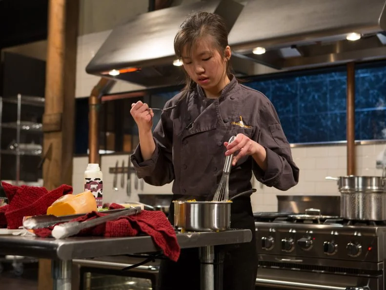 13 year old Allison Lee works on her entree that must include:  venison roast, butternut squash, fruity cereal macaroons and okra for Chopped Teen Week $25,000 tournament, as seen on Food Network's Chopped, Season 25.