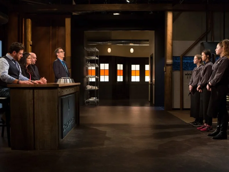 13 year old Eliza McKelvey, 13 year old Allison Lee and 14 year old Alexina Chasin stand before Chopped host Ted Allen and judges: Scott Conant, Alex Guarnaschelli and Chris Santos moments before finding out which teens will move on to cook in the final dessert round and which teen has been Chopped for Chopped Teen Week $25,000 tournament, as seen on Food Network's Chopped, Season 25.